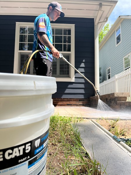 Woody's Home Services Technician Cleaning and Sealing Patio